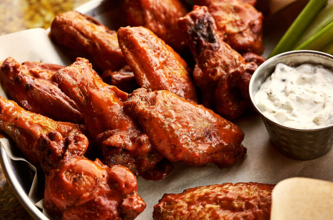 Hot wings served with ranch dressing, one of the top picks for what to eat at Full Throttle Distillery