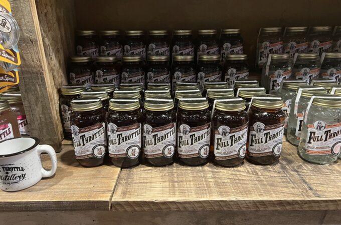 Jars of Full Throttle Distillery moonshine on display showcasing the handcrafted distilling process.