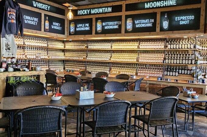 Rustic tasting room with whiskey and moonshine on display – fun for the whole family in a cozy setting.