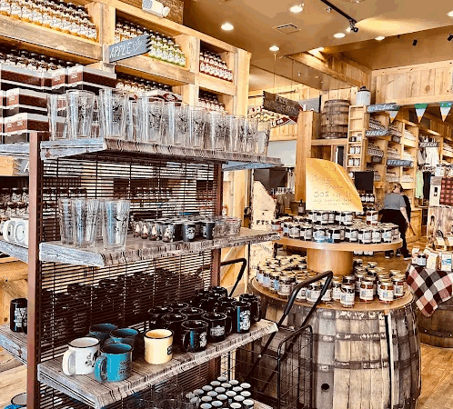 Interior of Full Throttle Distillery gift shop featuring moonshine jars, whiskey barrels, and branded merchandise