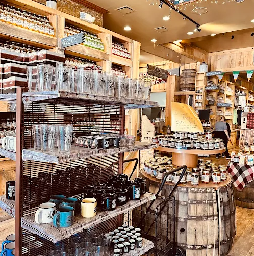 Interior of Full Throttle Distillery gift shop featuring moonshine jars, whiskey barrels, and branded merchandise