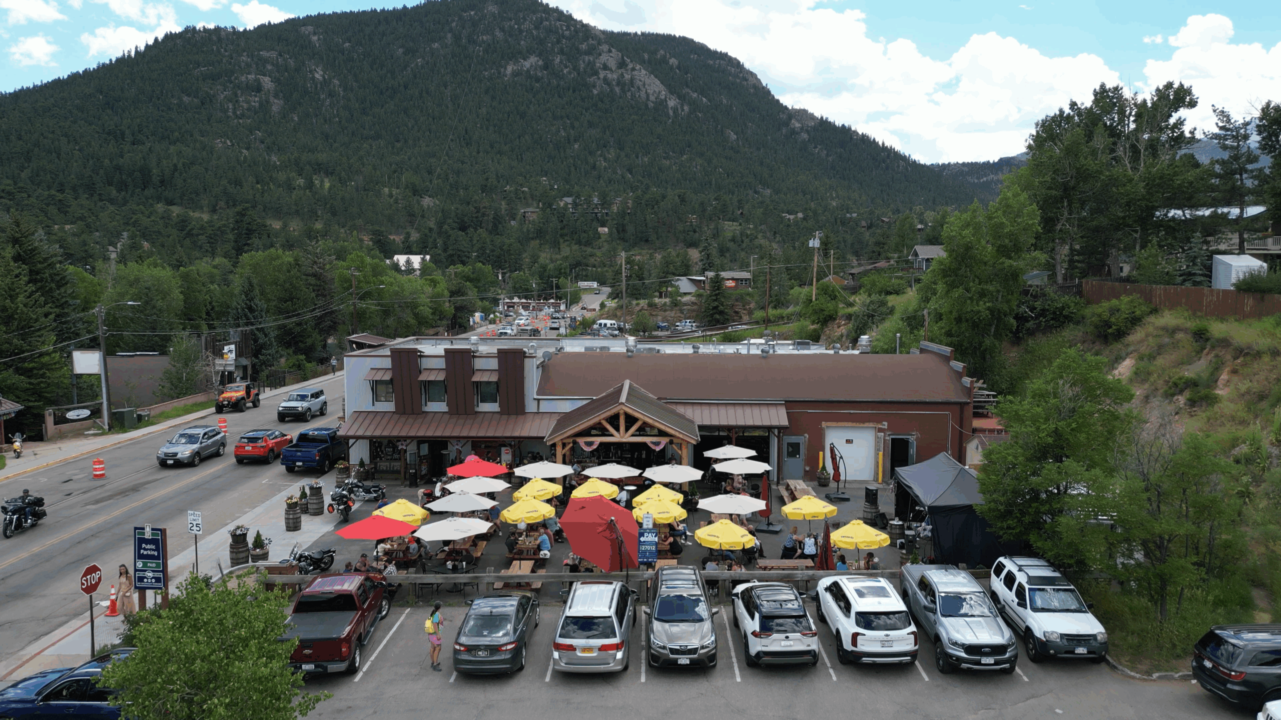 Estes Park distillery with mountain backdrop and outdoor dining area