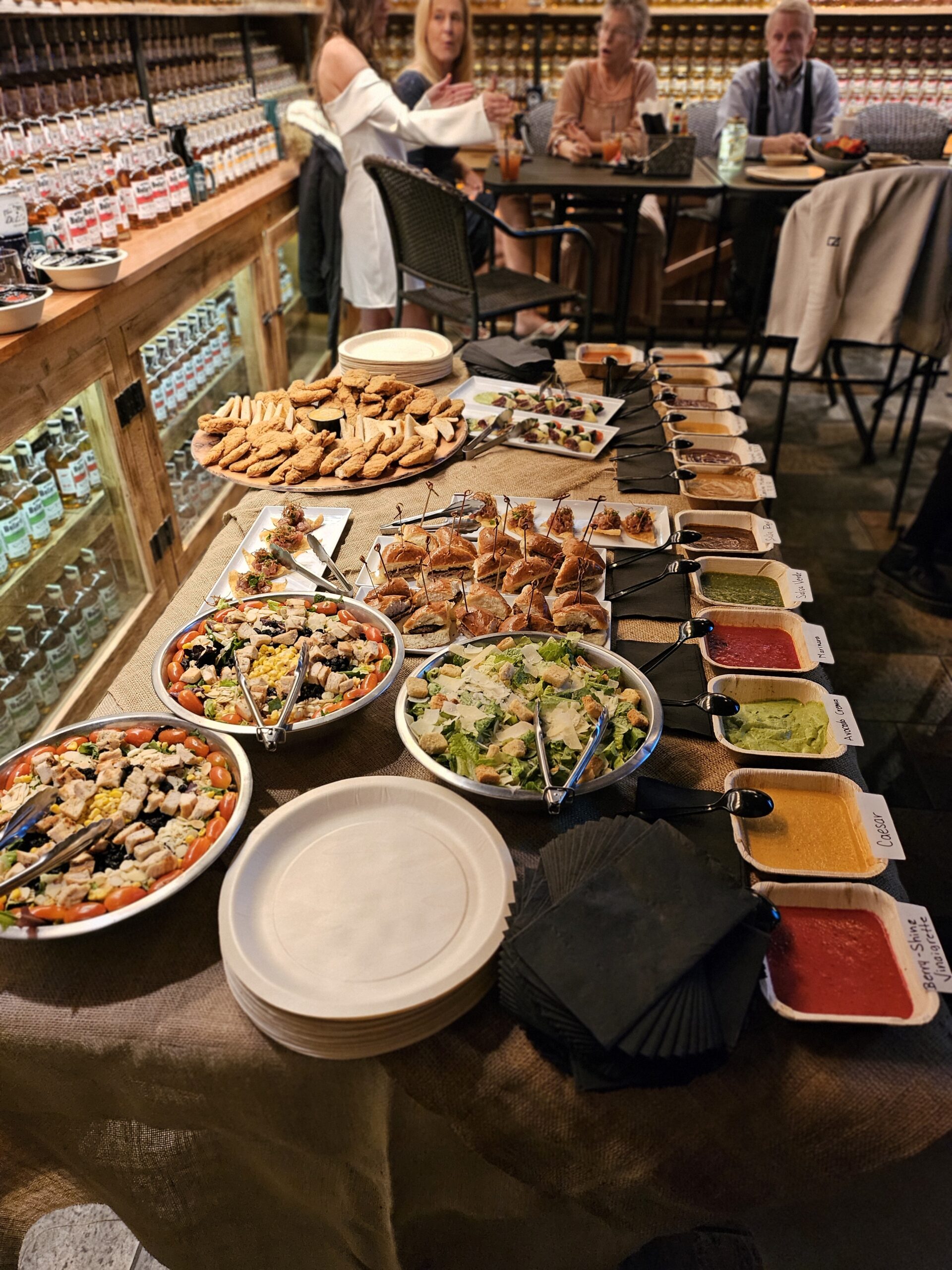 Buffet spread of salads, sliders, sauces, and appetizers at Full Throttle Distillery Smoke House & Grill in Estes Park.