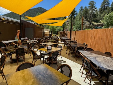 Panoramic view of the spacious covered outdoor area at Full Throttle Distillery, a versatile location for any event in Estes Park.