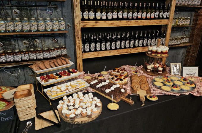 A colorful outdoor buffet catering spread with salads and plates at a Full Throttle Distillery event, perfect for gathering leftovers.