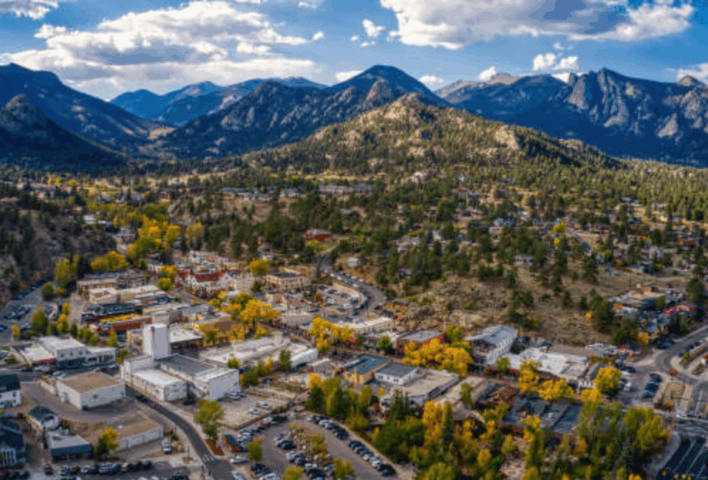 Aerial view of downtown Estes Park nestled in the mountains, highlighting attractions for an Estes Park Day Trip.