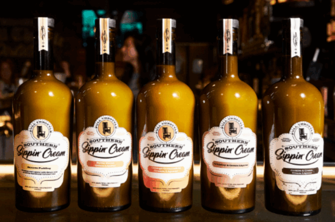 A lineup of five bottles of Full Throttle sippin cream, including Banana Pudding, Butter Pecan, Orange Creamsicle, and Cookies & Cream flavors.