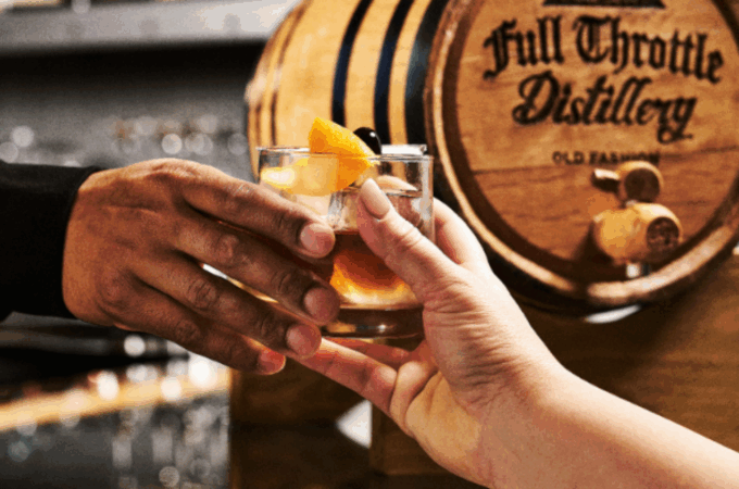 A couple toasting with drinks, highlighting a great idea for a date night in Branson.