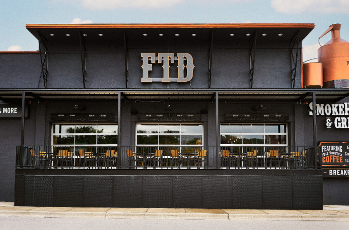 Exterior of Full Throttle Distillery with patio seating, home of the Best Breakfast in Branson.