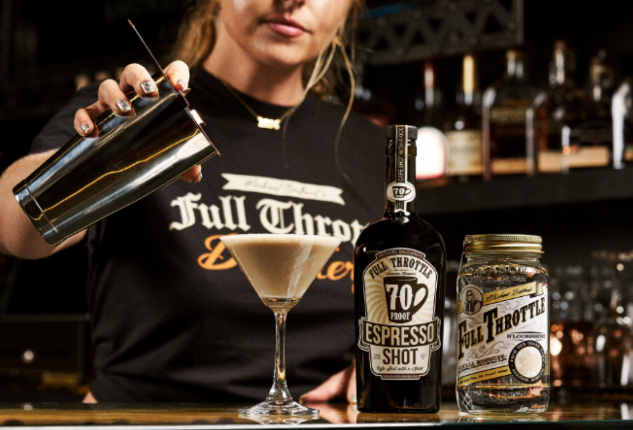 Barista grating chocolate over a creamy espresso martini for Hot Coffee Drinks for the Fall Season.