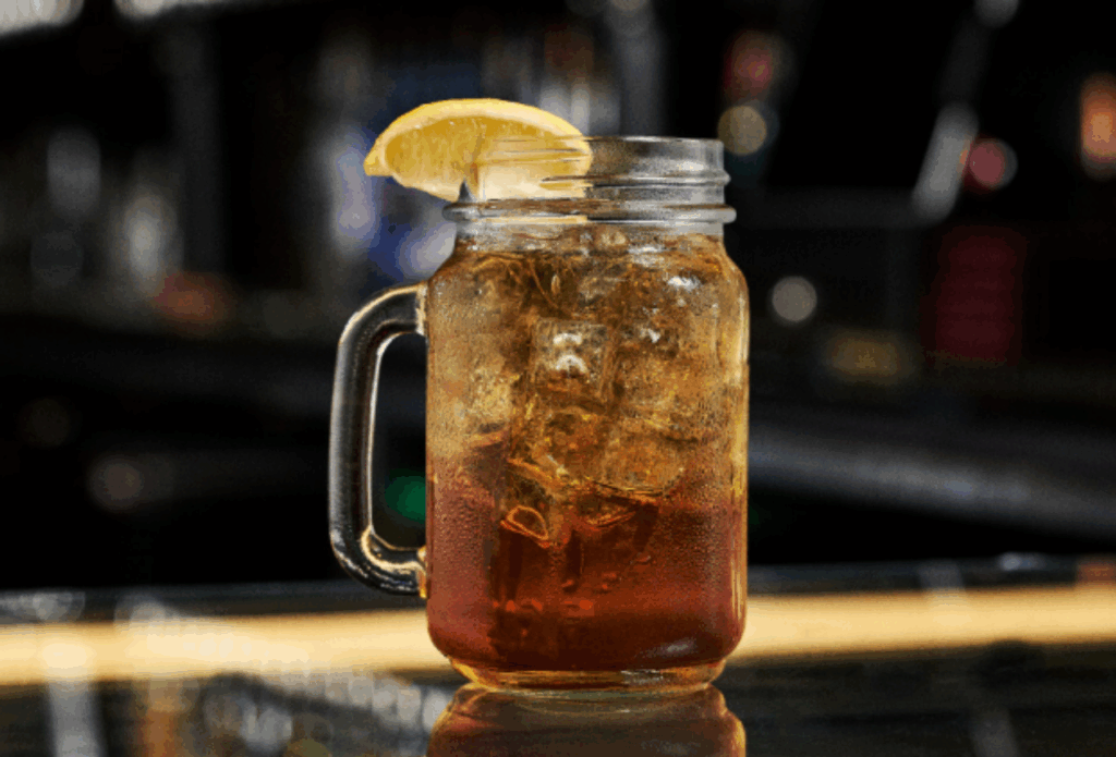 Easy Cocktails Using Spirits featuring a whiskey-style iced cocktail with lemon garnish