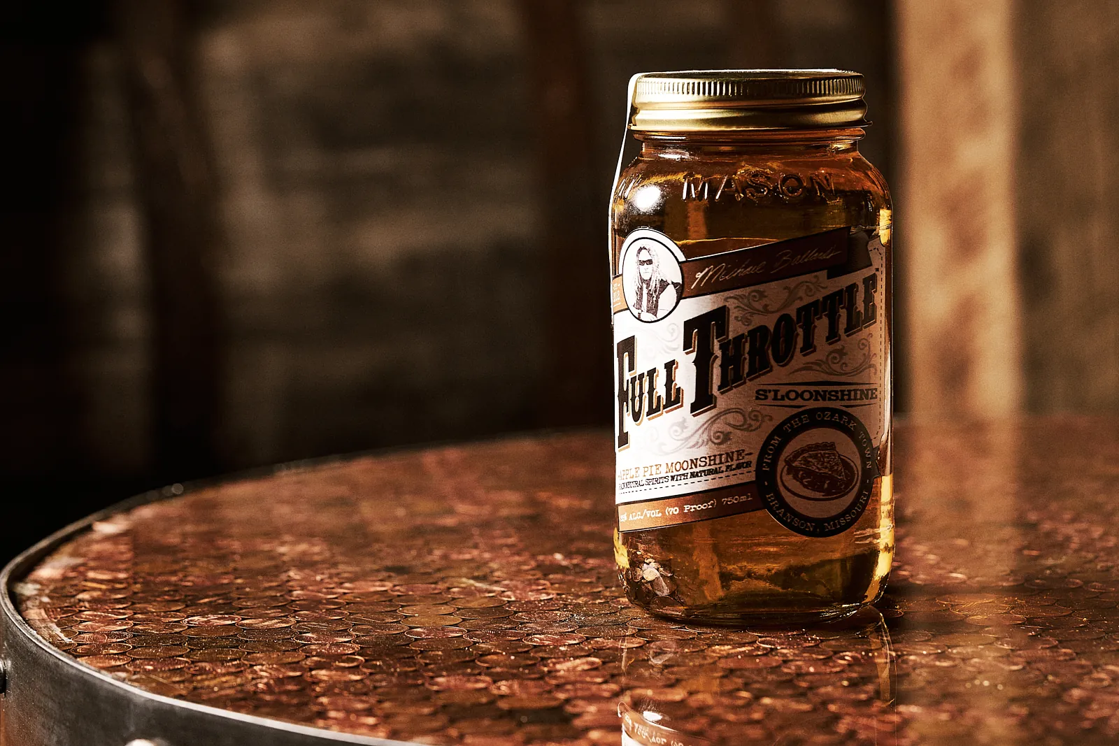 Jar of Full Throttle Apple Pie Moonshine on a copper penny table, perfect for learning how to taste moonshine