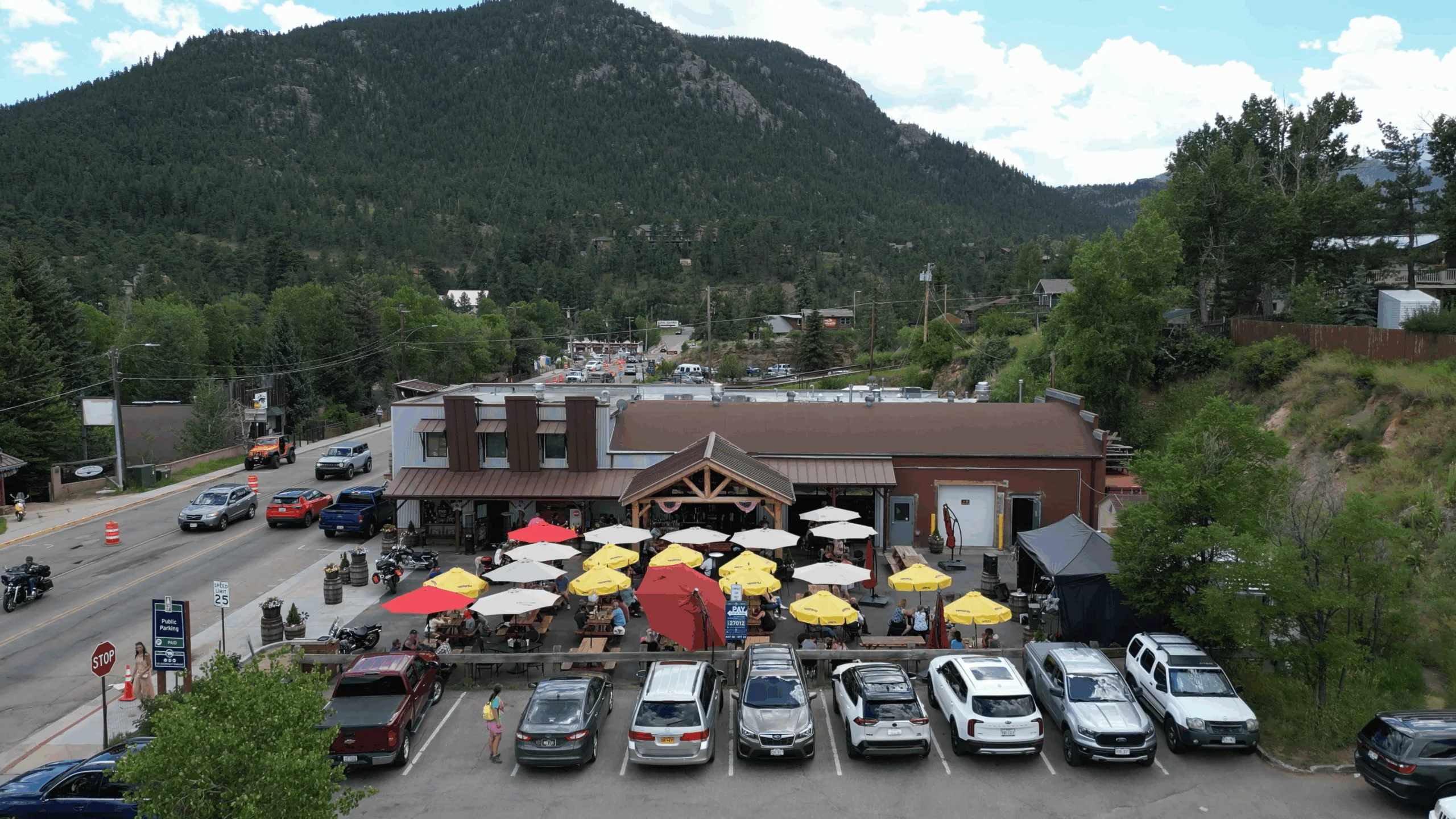 Estes Park distillery with mountain backdrop and outdoor dining area