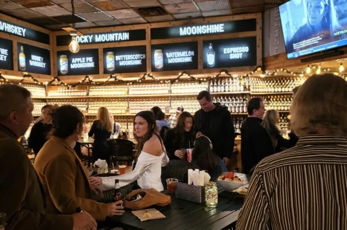 Couples and groups enjoying craft drinks at Full Throttle Distillery Smoke House & Grill in Estes Park—perfect for unique date nights.