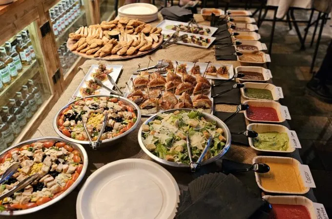 Buffet spread of salads, sliders, sauces, and appetizers at Full Throttle Distillery Smoke House & Grill in Estes Park.
