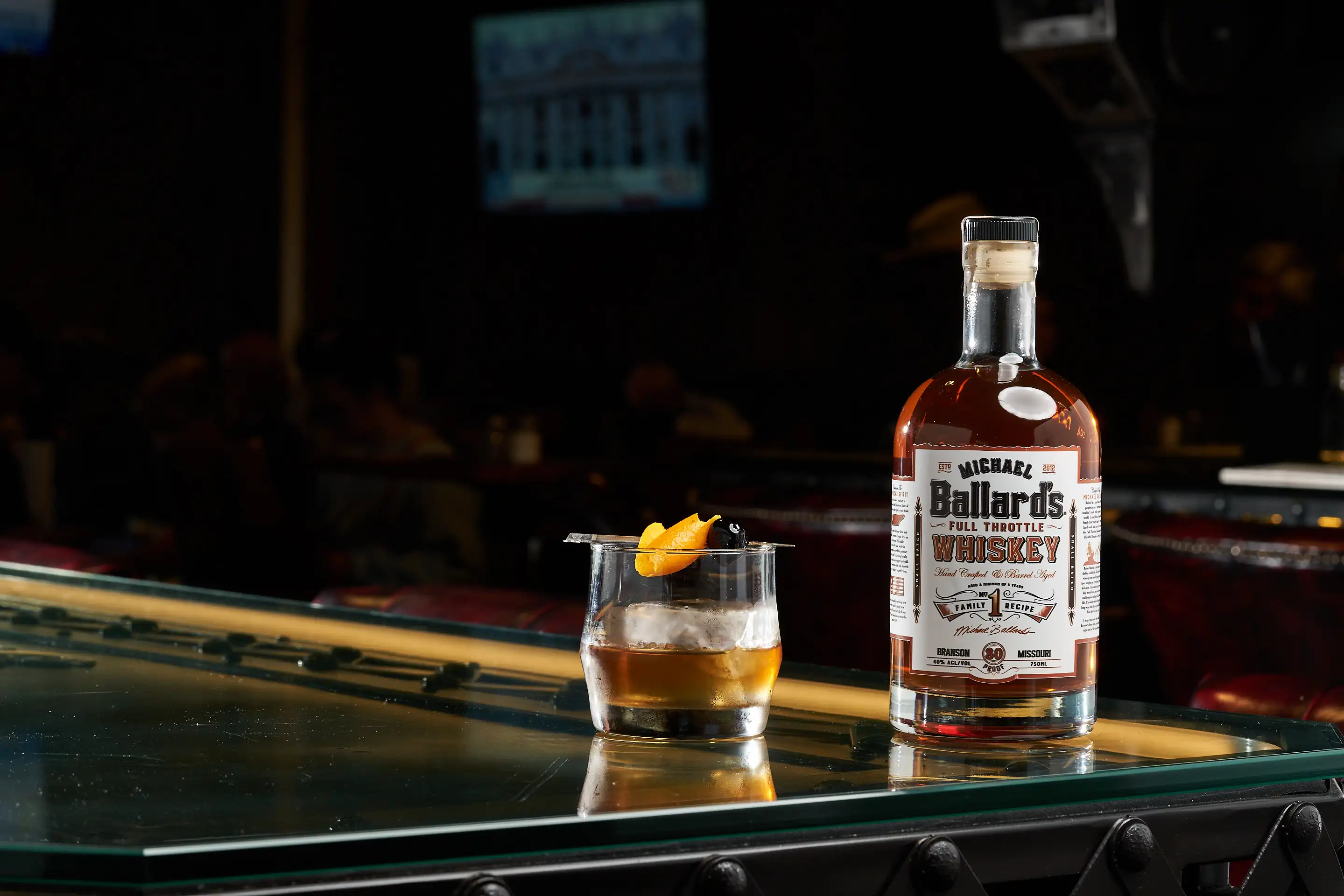 Michael Ballard's Full Throttle Whiskey bottle and a glass ready for a whiskey tasting at our Branson distillery.