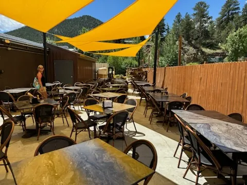 Panoramic view of the spacious covered outdoor area at Full Throttle Distillery, a versatile location for any event in Estes Park.