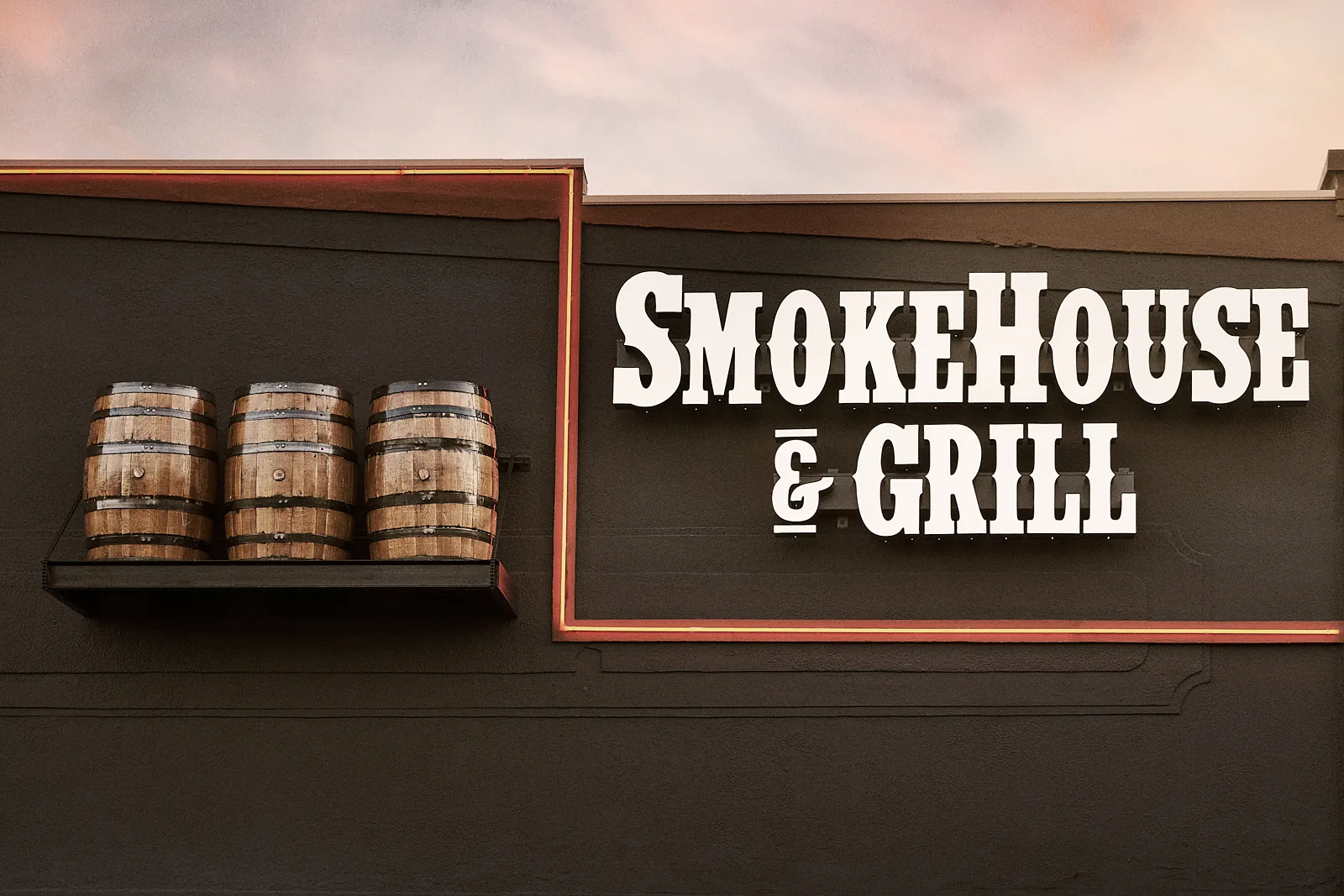 A close-up of the "Smoke House & Grill" sign, representing the home of authentic BBQ seasonings for a smoked flavor.