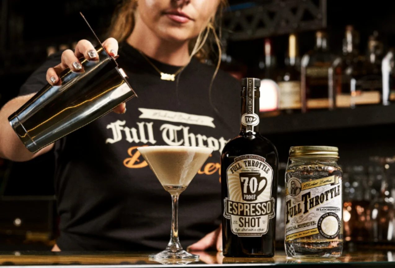 Barista grating chocolate over a creamy espresso martini for Hot Coffee Drinks for the Fall Season.