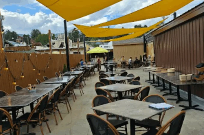 Outdoor dining patio setup at Full Throttle Distillery & Grill in Estes Park, perfect for Catering for Your Events.