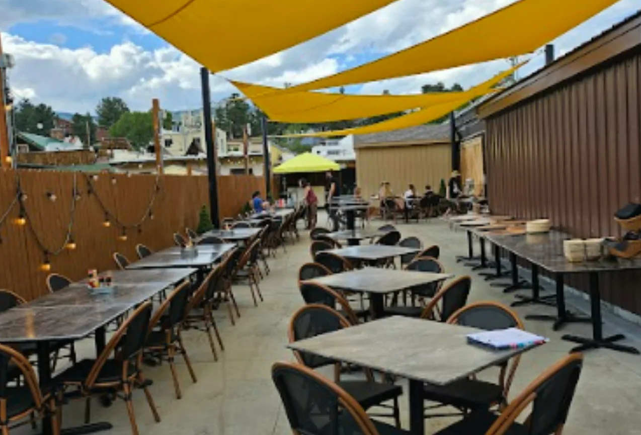 Outdoor dining patio setup at Full Throttle Distillery & Grill in Estes Park, perfect for Catering for Your Events.